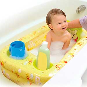 baby being washed in an inflatable baby bathtub
