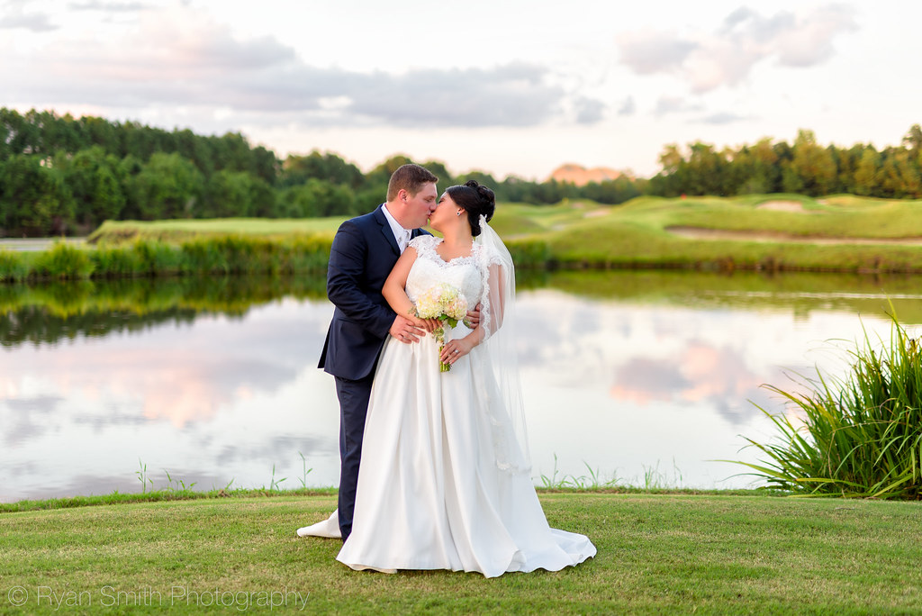 After wedding kiss in front of the golf course - Dye Club at Barefoot Resort