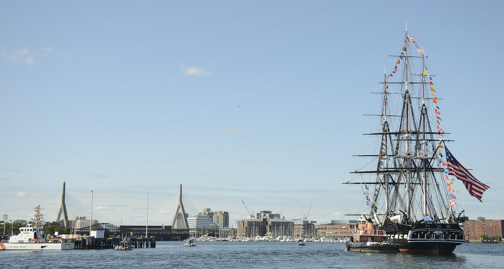 USS Constitution is tugged through Boston Harbor.