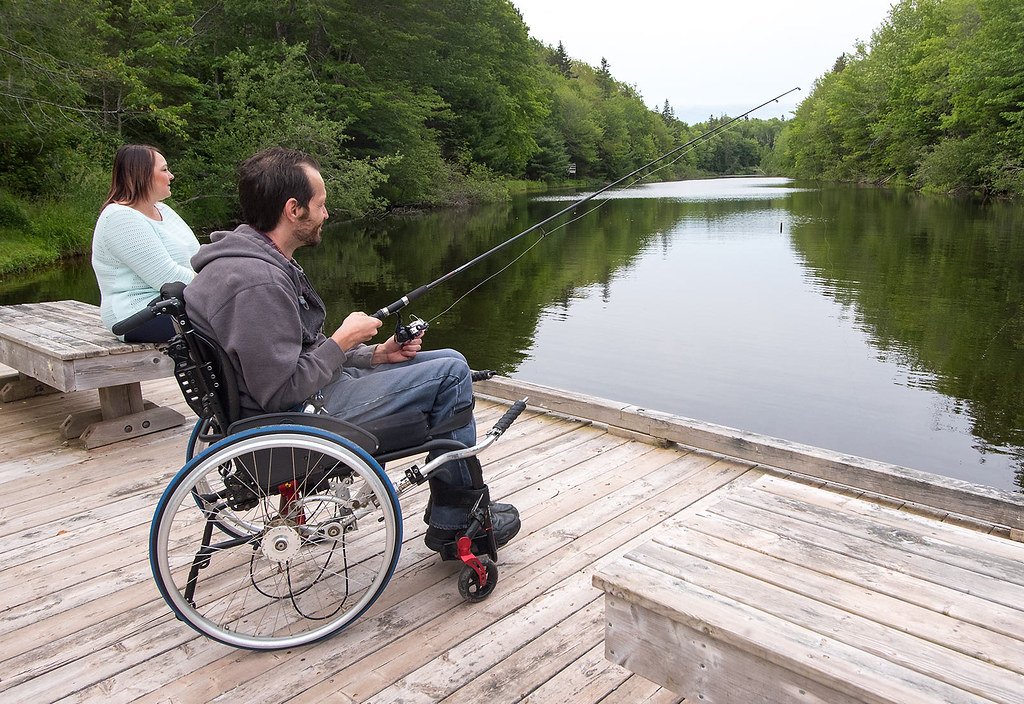 Couple walking trails and fishing at Mooney's Pond, Peakes, Prince Edward Island.